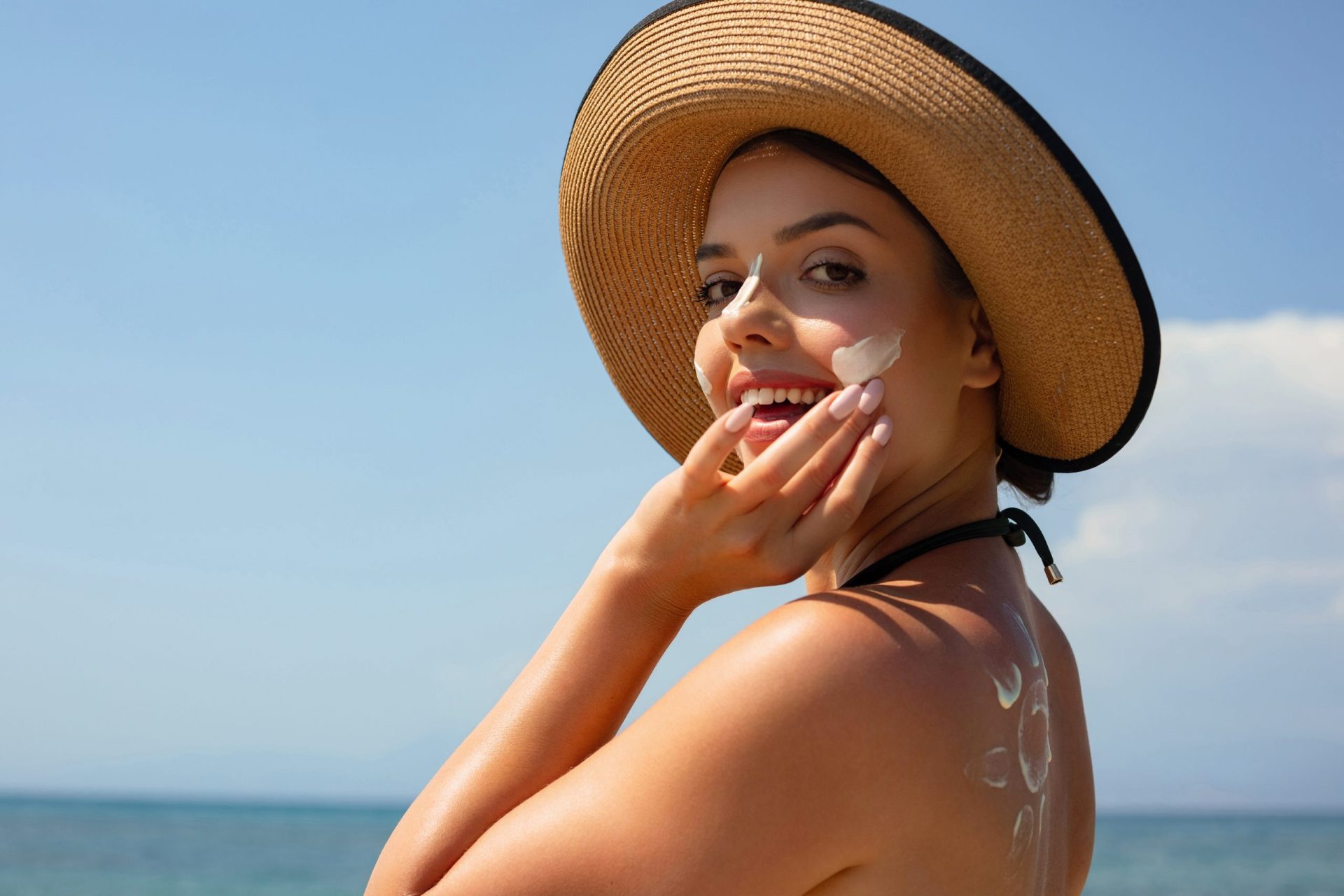 woman applying sunscreen to her face